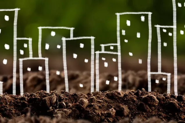 Drawn houses in white chalk on top of a picture of soil. Foto, drawing