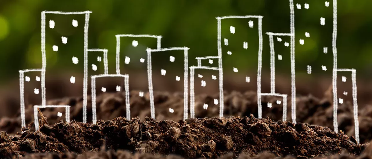 Drawn houses in white chalk on top of a picture of soil. Foto, drawing