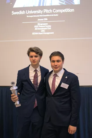 Two people holding a trophy. Photo.  